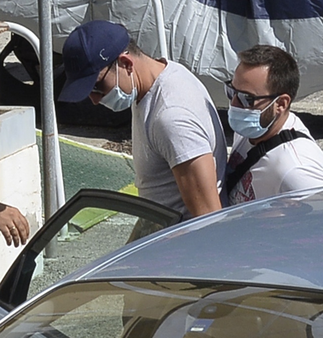 Maguire is escorted by police officers at the police station on the Aegean island