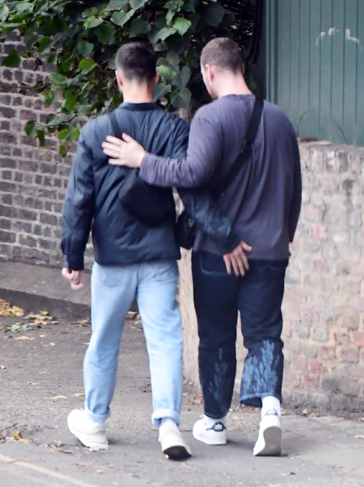 Francois placed a hand on Sam's bum as they headed off down the street