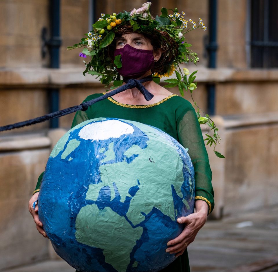  One woman from the Extinction Rebellion protest in Camberidge holds a globe of the world