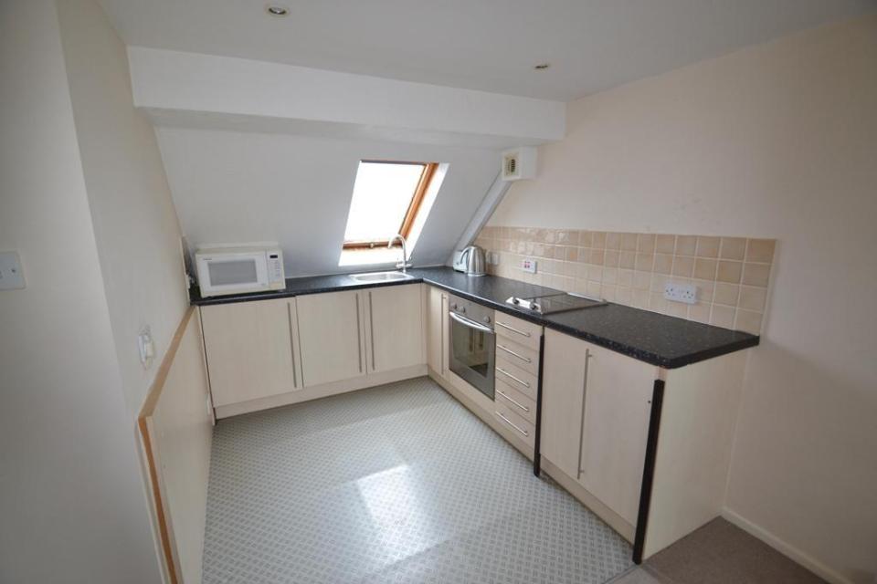 The kitchen area of the studio flat