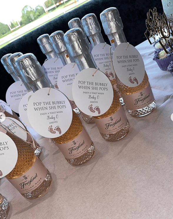 The Radfords gave out mini bottles of pink fizz so guests can toast the baby once she arrives