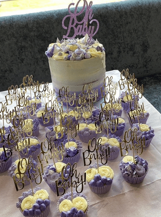 Guests were treated to a huge purple and cream layer cake with dozens of matching cupcakes