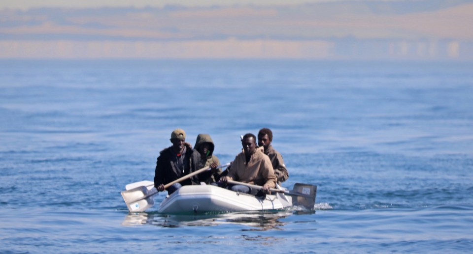 Migrants using make-shift paddles for their crossing