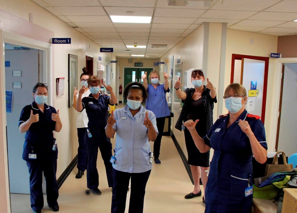 Millie (centre) has returned to work at the hospital which saved her