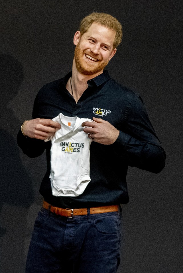 Prince Harry presented with an Invictus Games baby suit for his newborn son Archie during the launch of the Invictus Games last year at The Hague