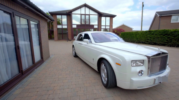 Khan’s glimmering white Rolls Royce outside his home