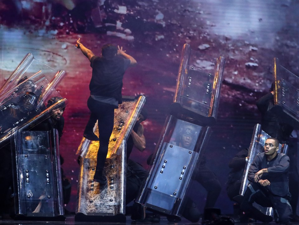 The dance included smoke, sirens and backing dancers with riot shields