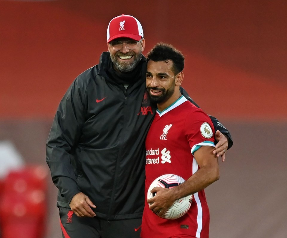 Liverpool boss Jurgen Klopp congratulates his forward after he collected the match ball