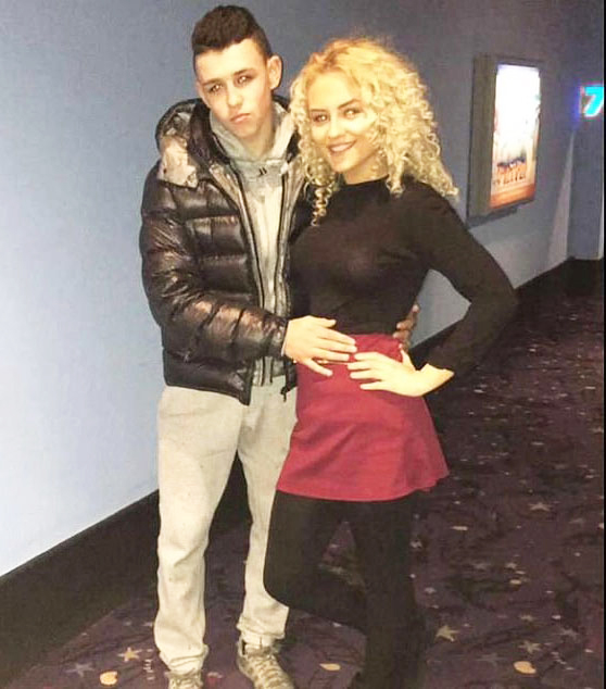 a man and a woman are posing for a picture in a movie theater