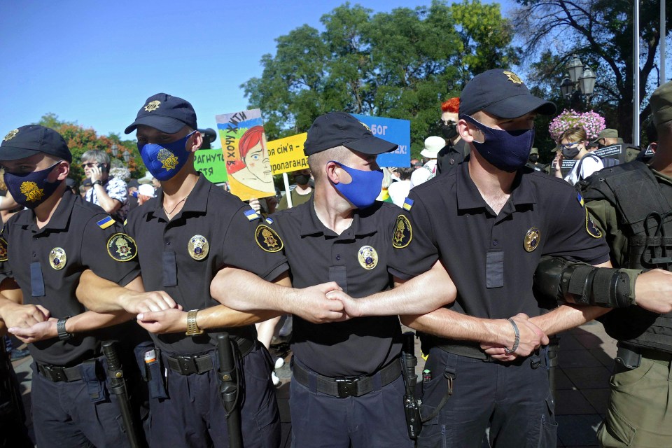 Cops wear facemasks at an LGBT demonstration