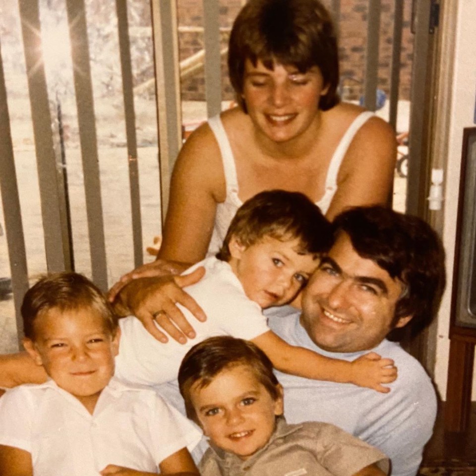 Ant pictured as a child hugging his father and mother