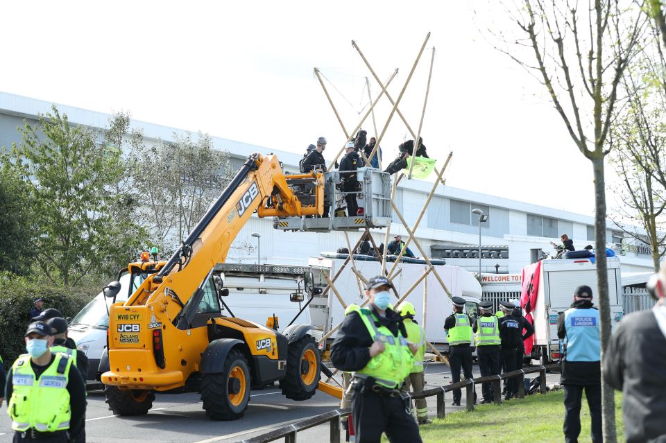 Protesters were today pictured using a cherry picker to remove protesters