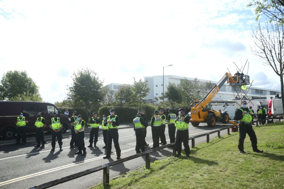 A line of police stand by the protests