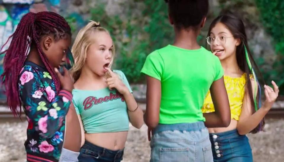 Amy steals her brother's T-shirt to wear as a crop top to impress her friends