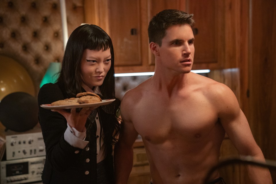 Hunky Robbie Amell flexes his muscles in the movie