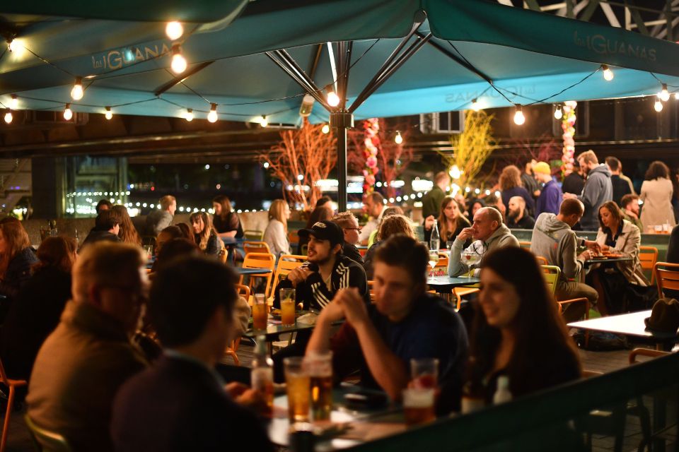 Enjoying the last of their socialising, friends gather at Las Iguanas restaurant and bar in London