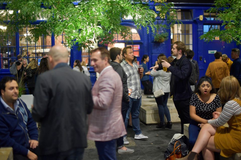 People gather outside The Shipwrights Arms near London Bridge in London