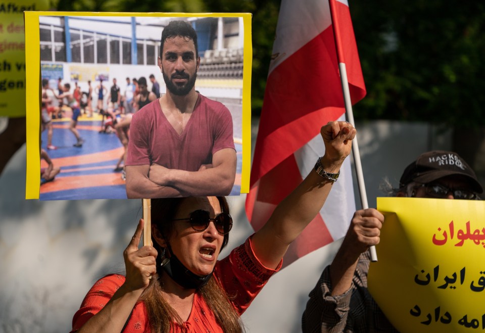 A supporter of the National Council of Resistance brandishes a photograph of the executed champion