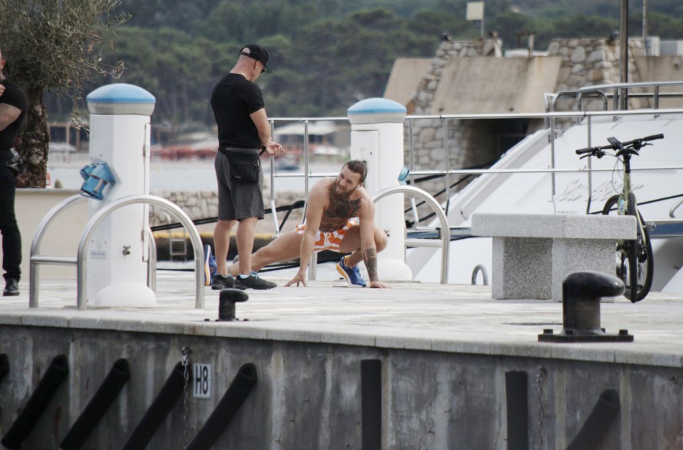 McGregor stretches out on the quayside in Calvi three days after the alleged bar incident