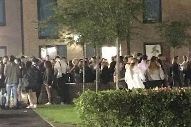 Students mingling outside halls at the University of Manchester