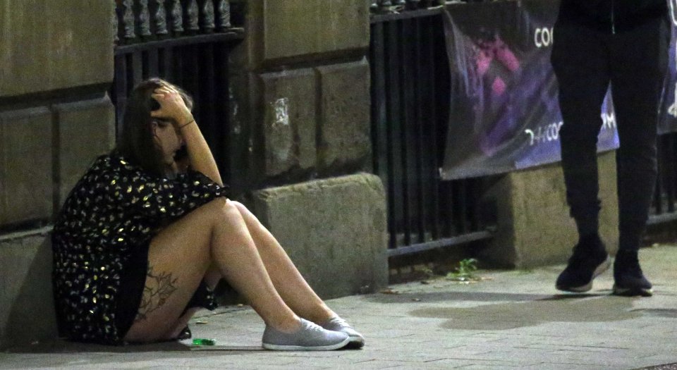 A young woman sits on the footpath in Leeds last night