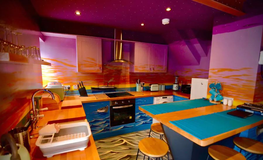 The kitchen murals feature waves and sunsets to imitate the view from the boat