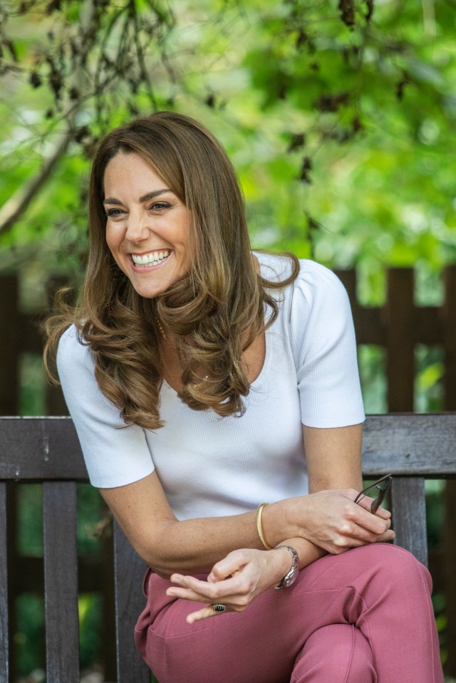 Kate beamed during the engagement sitting socially distanced on a wooden bench