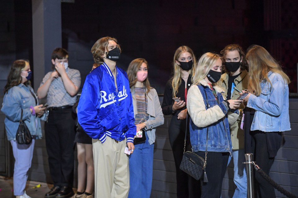 Revellers wore masks as they waited to get into bars 