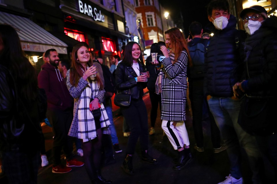 Drinkers gathered on the streets after bars and restaurants in London closed