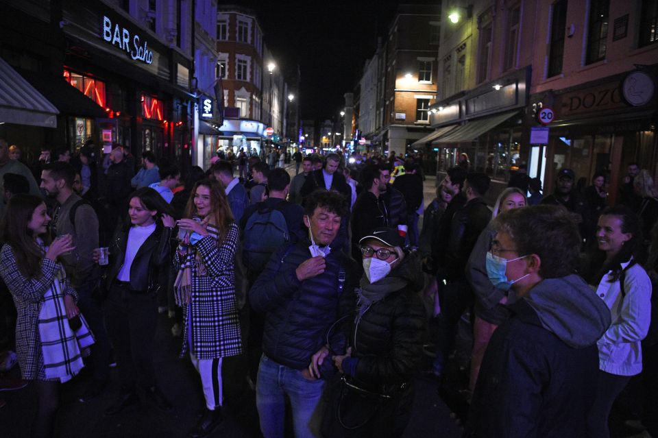 People gathered outside bars to finish their last drinks