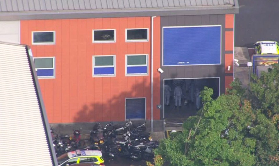 Forensic officers inside the custody centre as they probe the murder