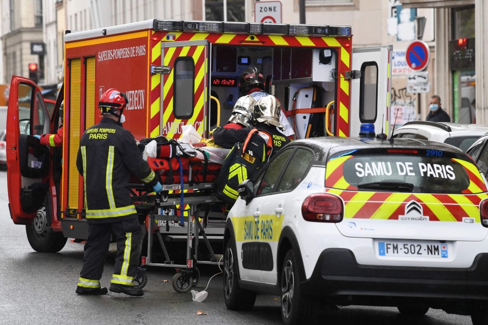 Emergency services load a victim into an ambulance