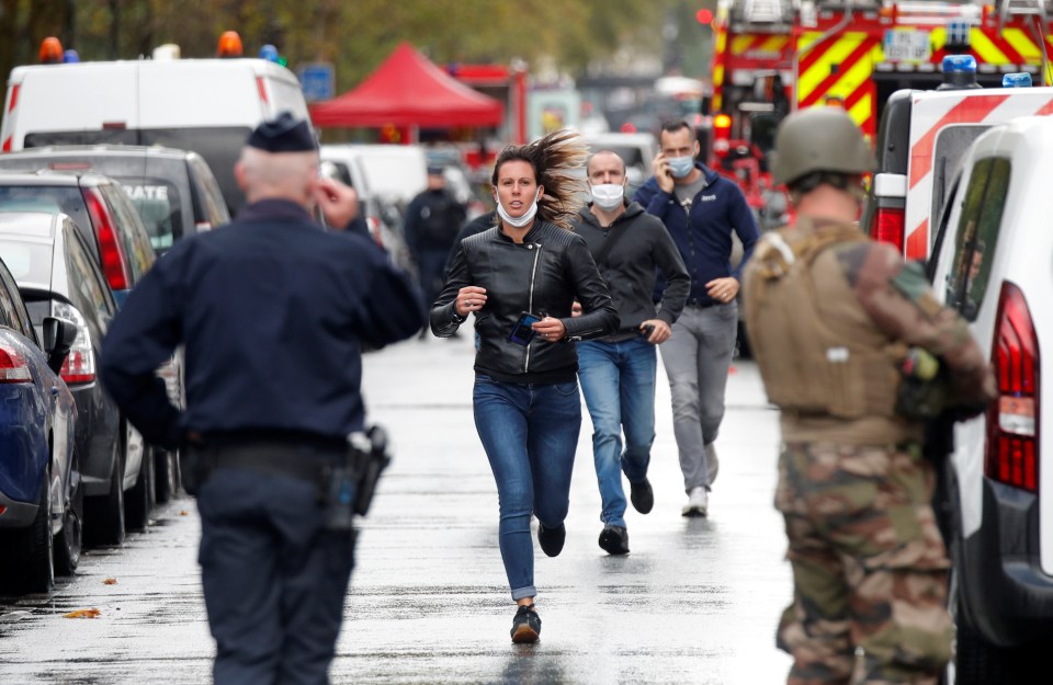 People in masks run following the horror attack