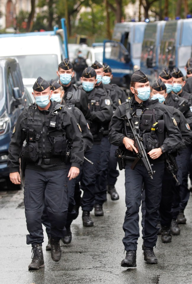 Tooled-up French police arrive to secure the scene near the old Charlie Hebdo office