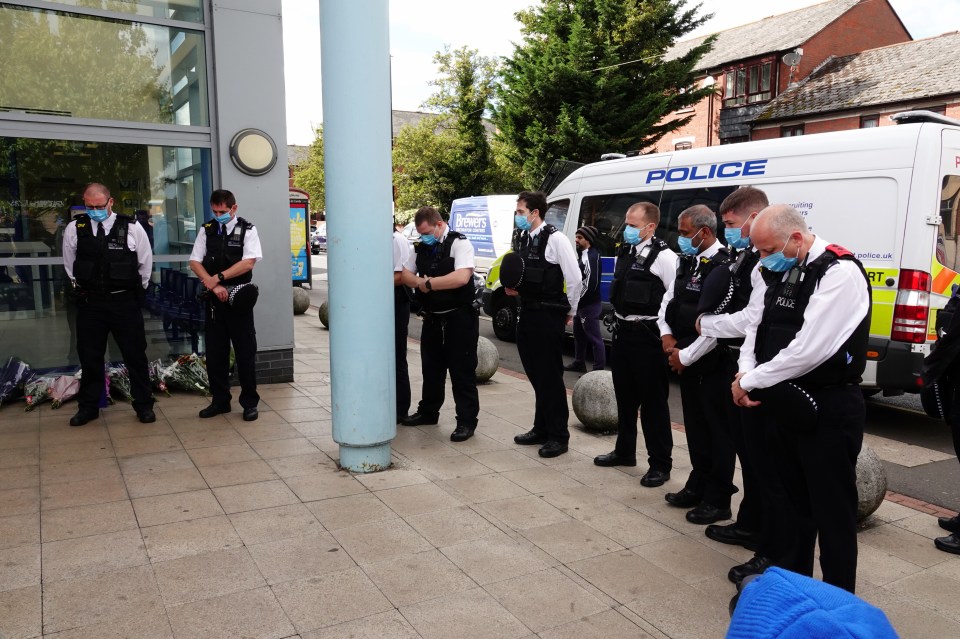 The cops removed their hats and bowed their heads for a moment of silence