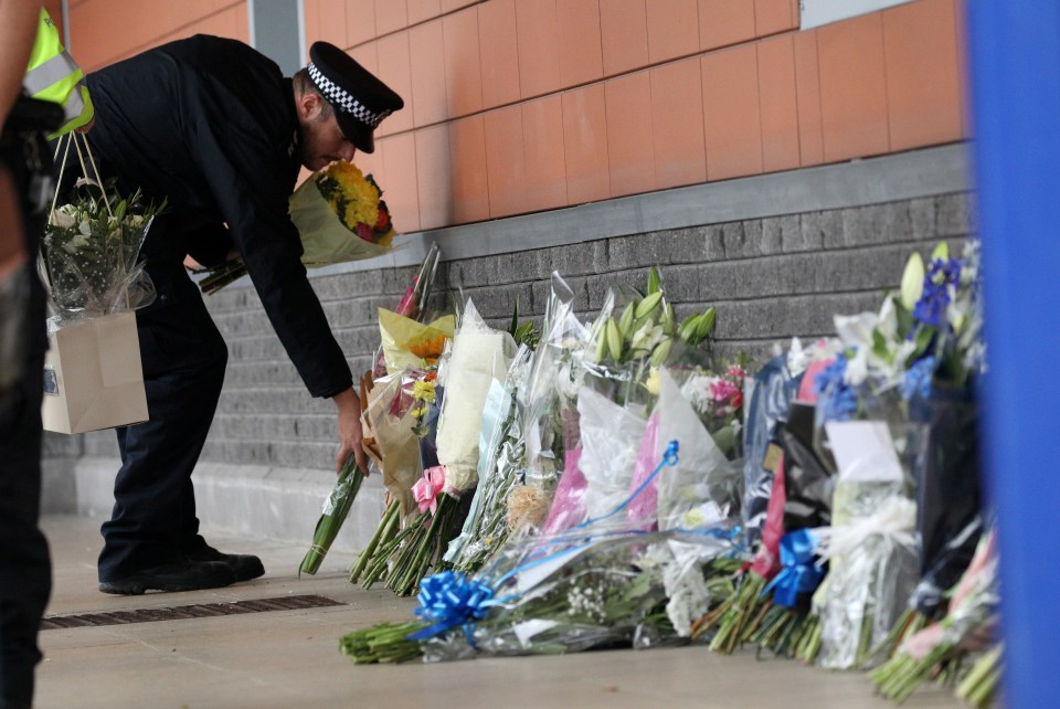 Dozens of bunches of flowers have been left in memory of the officer