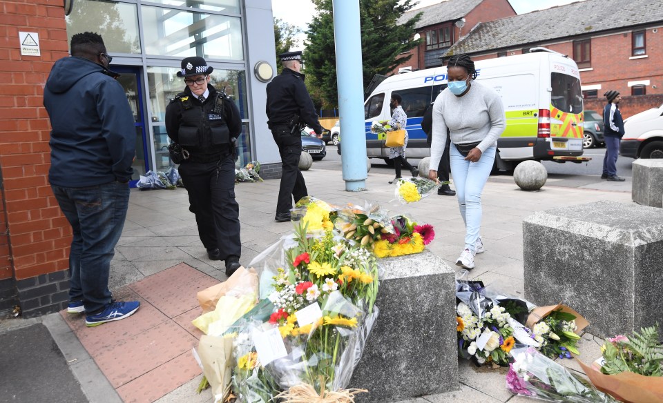 Members of the public bring flowers to the scene at Croydon Custody centre 