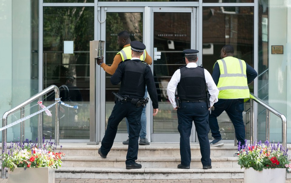 Police at the cordon surrounding the flats at Anderson Heights