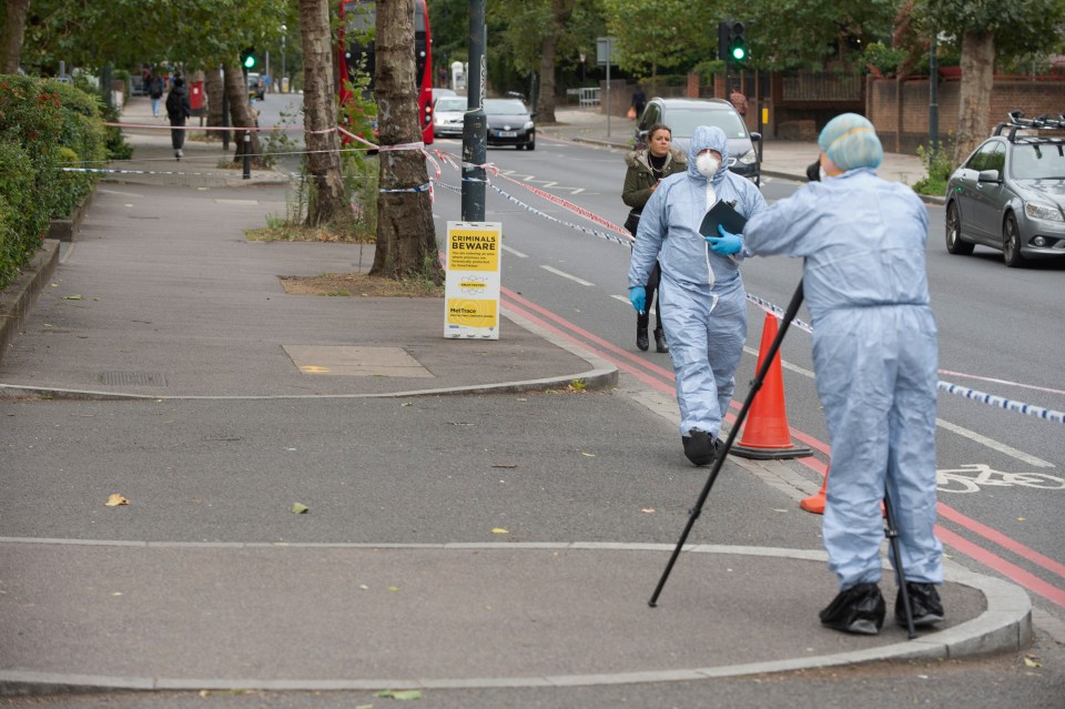 A forensic team investigating the road outside the Norbury flats