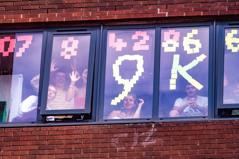 Students trapped inside their halls have used post-it notes to write signs