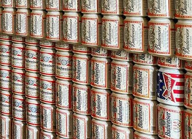 A closer look shows the walls are all covered in empty cans of Budweiser