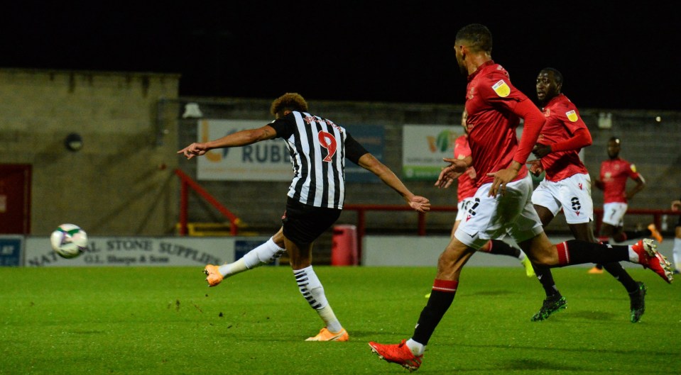 Joelinton curves the fourth and best of Newcastle's seven goals at Morecambe, completing his double