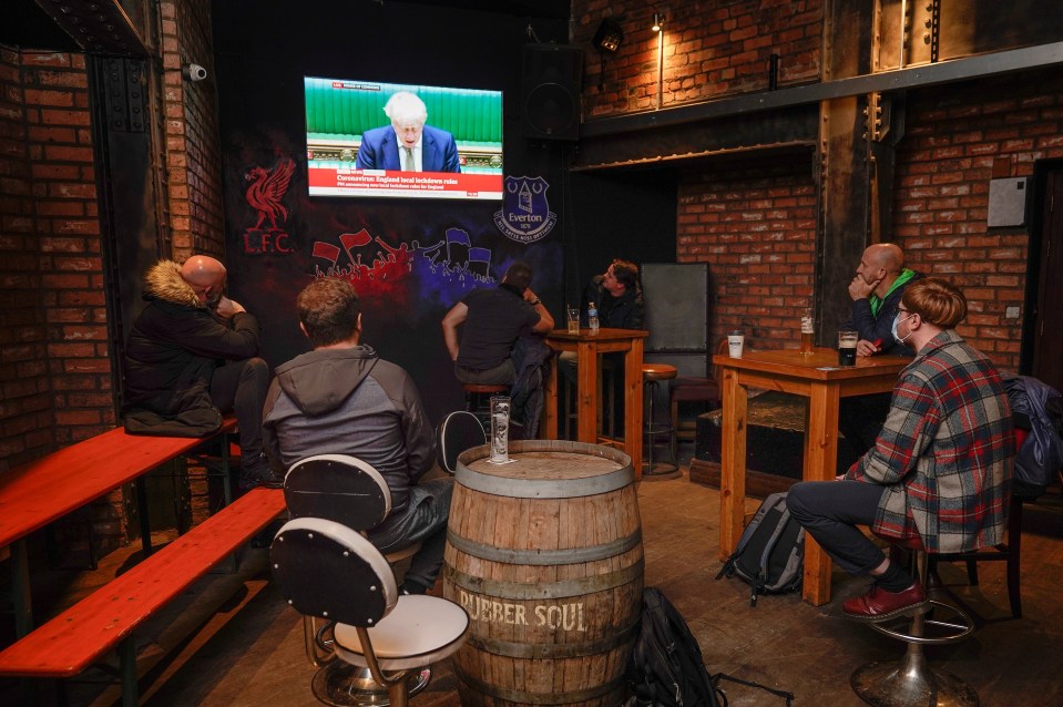 People in a Liverpool pub watching the PM's announcement 