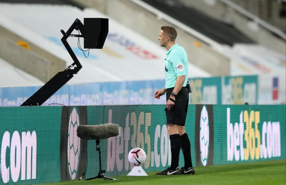 Ref Craig Pawson consults the VAR monitor before awarding a penalty 