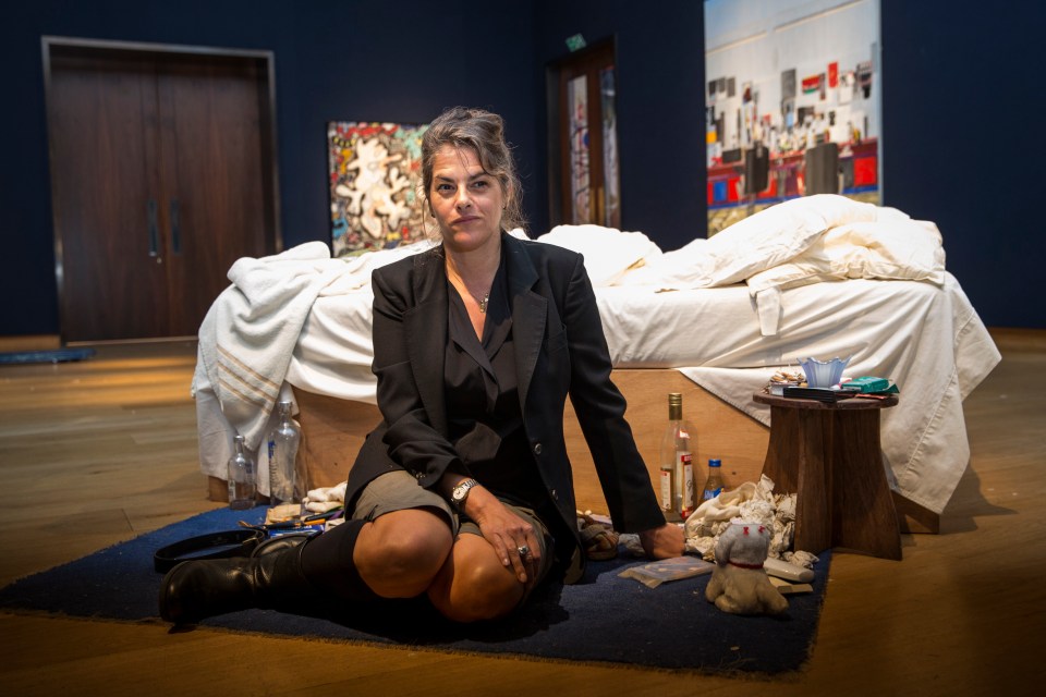 Tracey Emin sits beside her famous installation My Bed in 2014