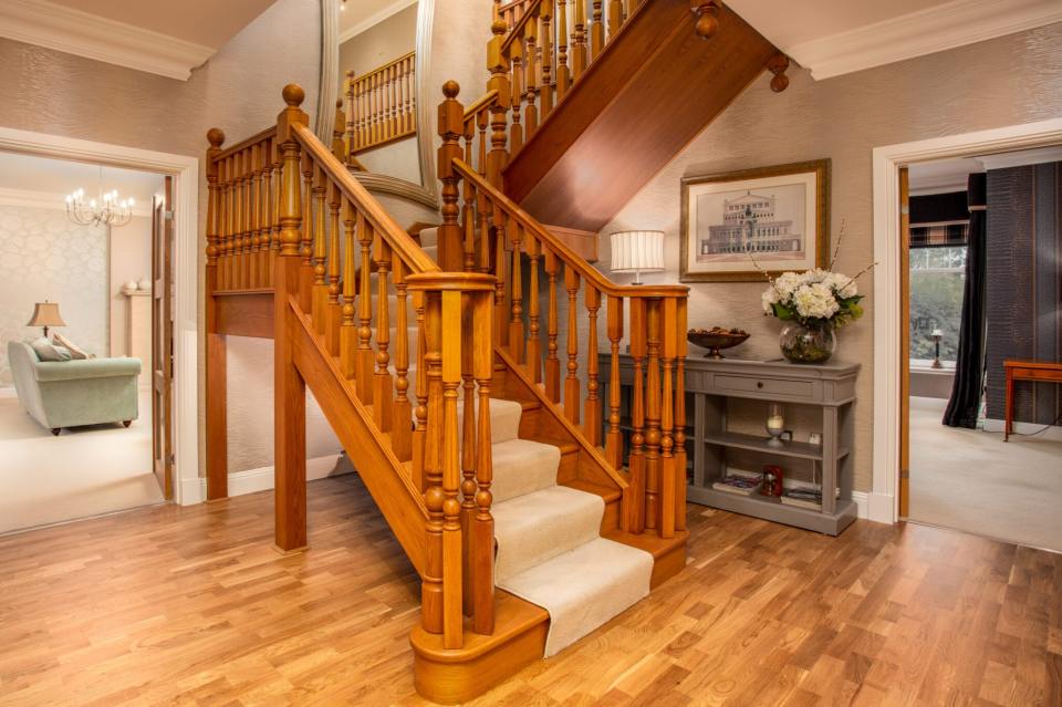 The gorgeous property boasts a grand staircase - and even its own lift