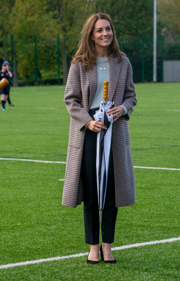 The Duchess of Cambridge wrapped up in a baby blue jumper and checked coat both from Massimo Dutti