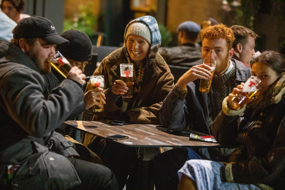 People are wrapped up nice and warm and enjoy a bevvy outside