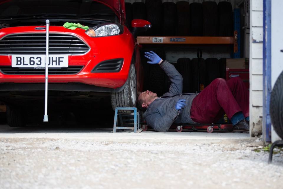 Dan returns to work but finds himself trapped under a car