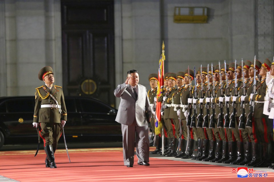 Kim saluting a guard of honour at the start of the parade